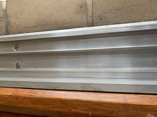 Sliding glass door aluminum track close-up